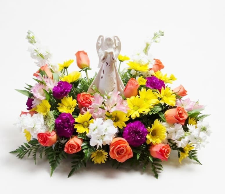 Colorful floral arrangement with an angel figurine in the center