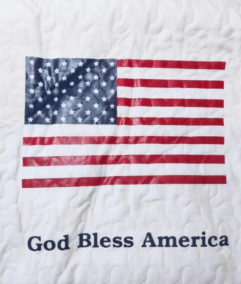 Quilt with an American flag and the words God Bless America