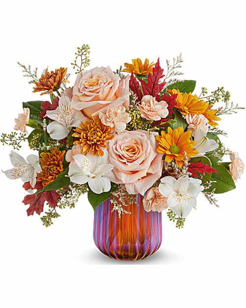 Teleflora's Fall Luxe Bouquet - Teleflora's Fall Luxe Bouquet blends soft peach blooms with golden autumn accents, artfully arranged in Teleflora's Amber Glow Votive. With its rich, iridescent finish, this refined fall centerpiece adds a warm glow to gatherings-and shines on as a votive after the blooms are gone.