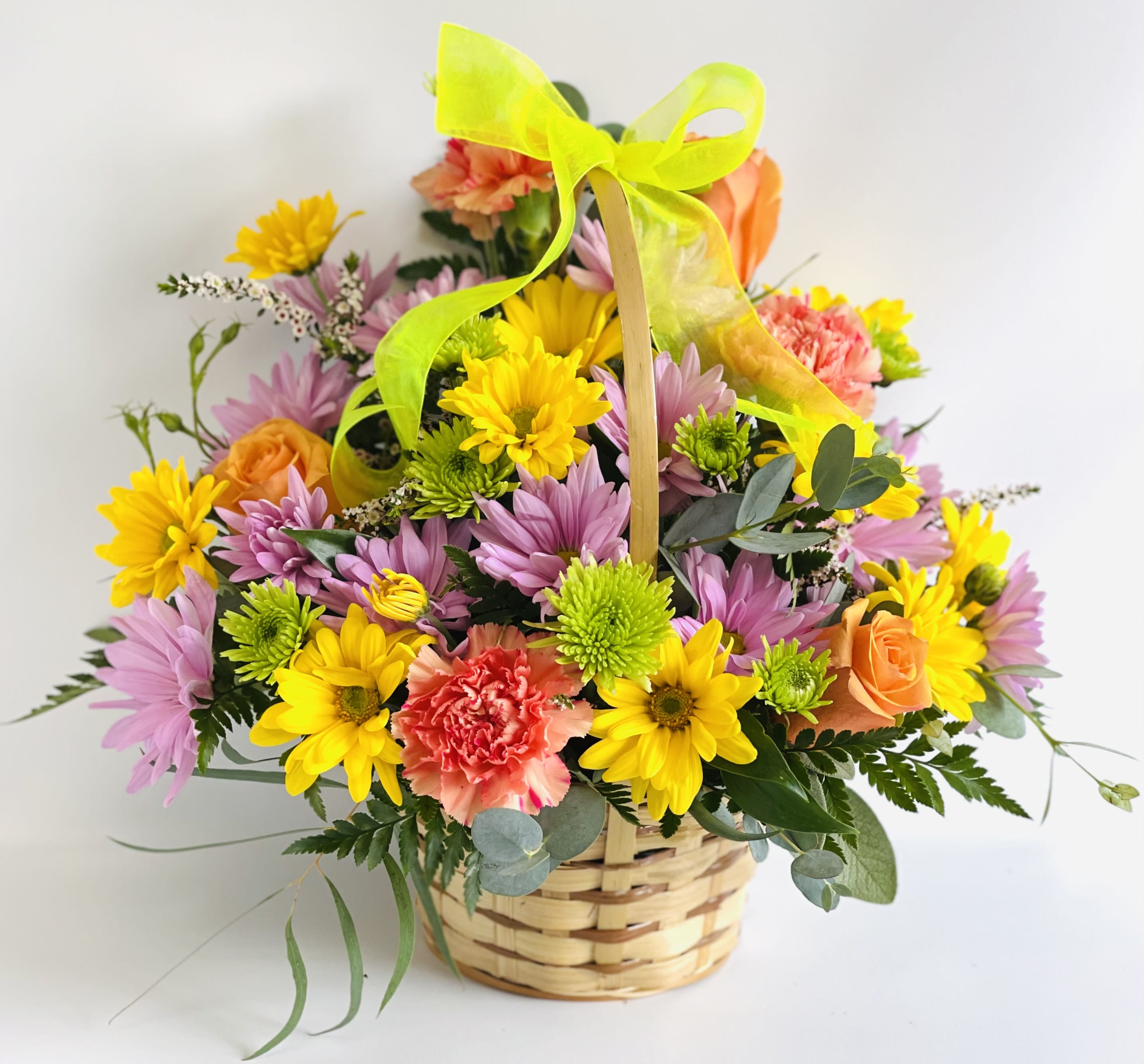 Basket of mixed flowers with a neon ribbon bow