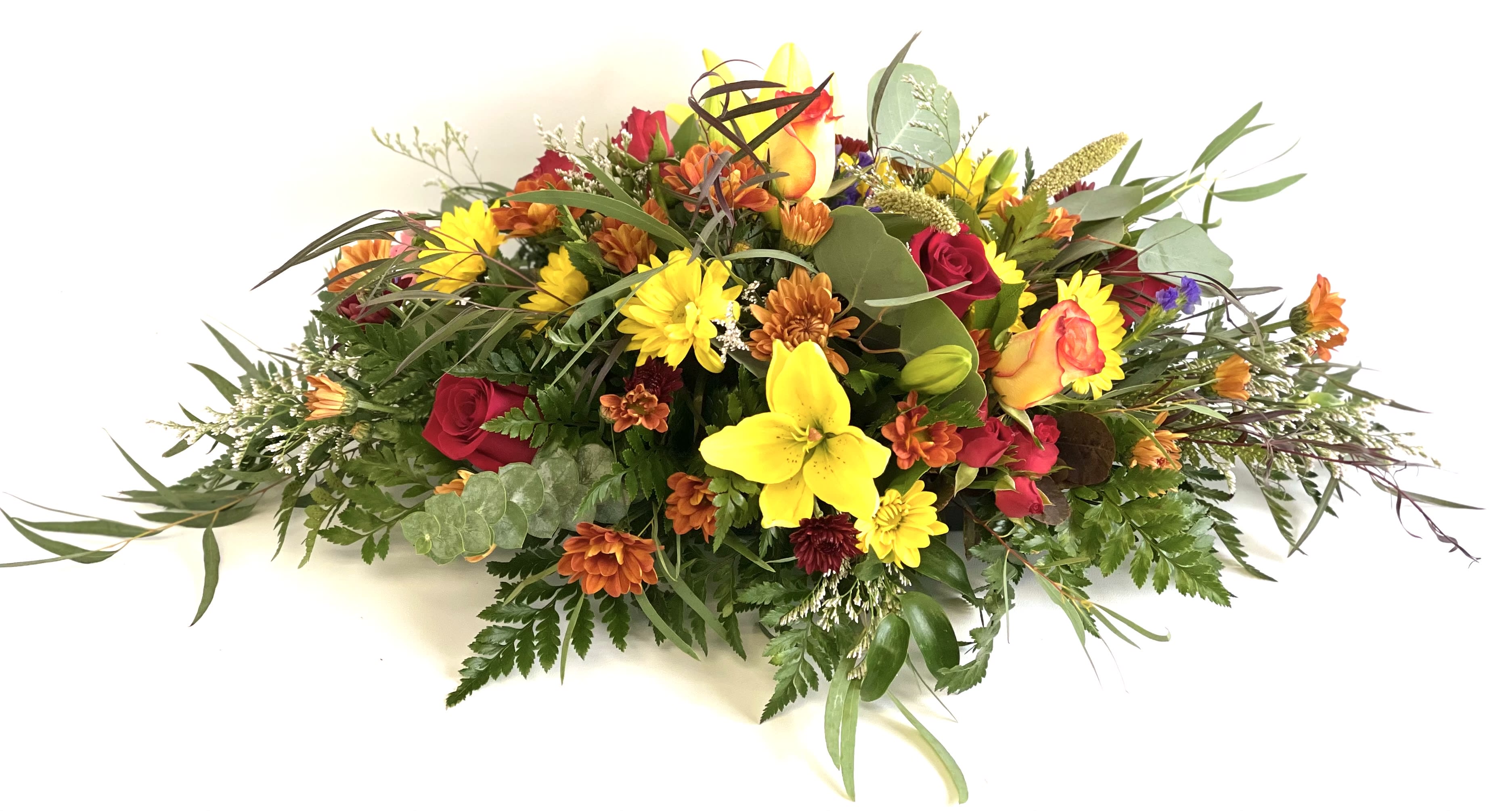 Mixed bouquet with yellow lilies, red roses, and orange daisies