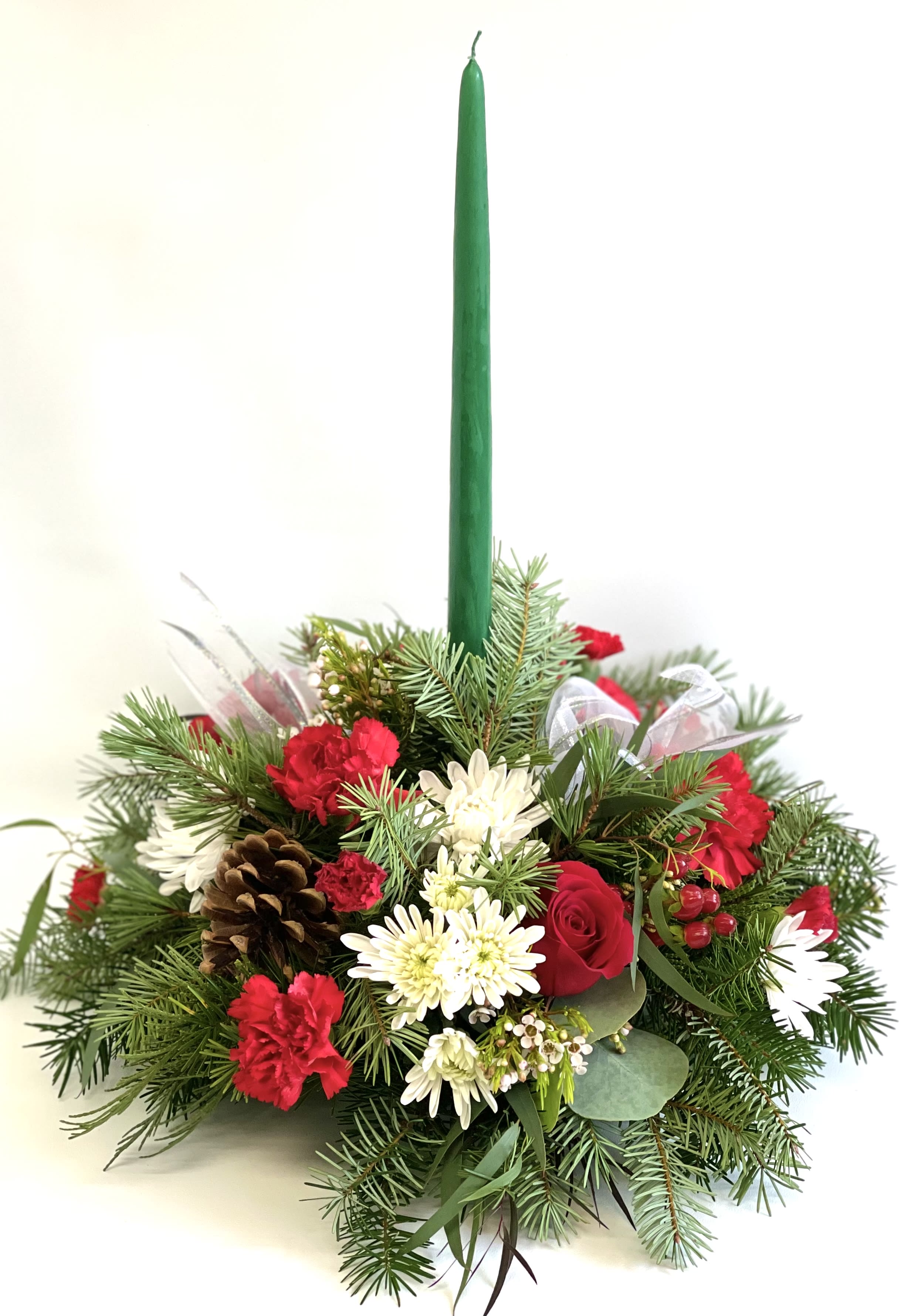 Holiday centerpiece with a green taper candle and red-white flowers