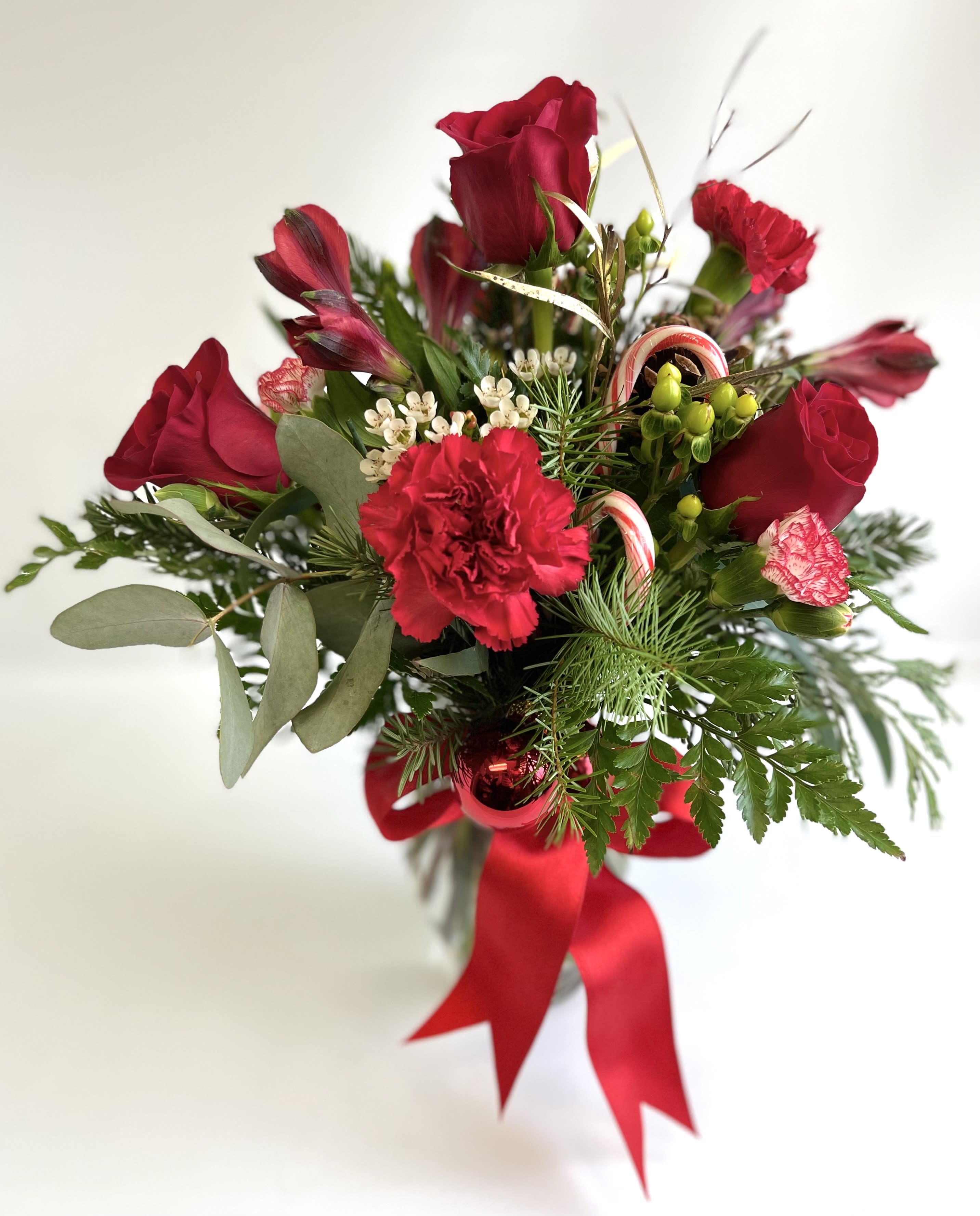 Red roses and carnations with candy canes and a red ribbon