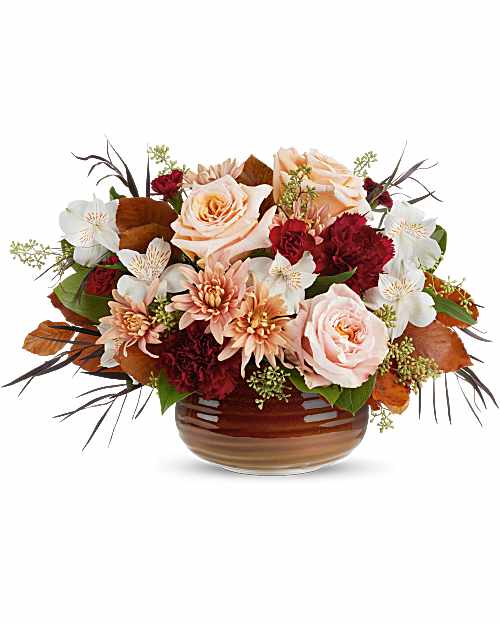 Teleflora's Sunset Stone Centerpiece - Teleflora's Sunset Stone Centerpiece glows with rich reds and soft peach tones, artfully arranged in Teleflora's Rustic Ember Bowl. With its warm, glazed finish and food-safe design, it's a striking fall centerpiece that transitions beautifully into seasonal serving.