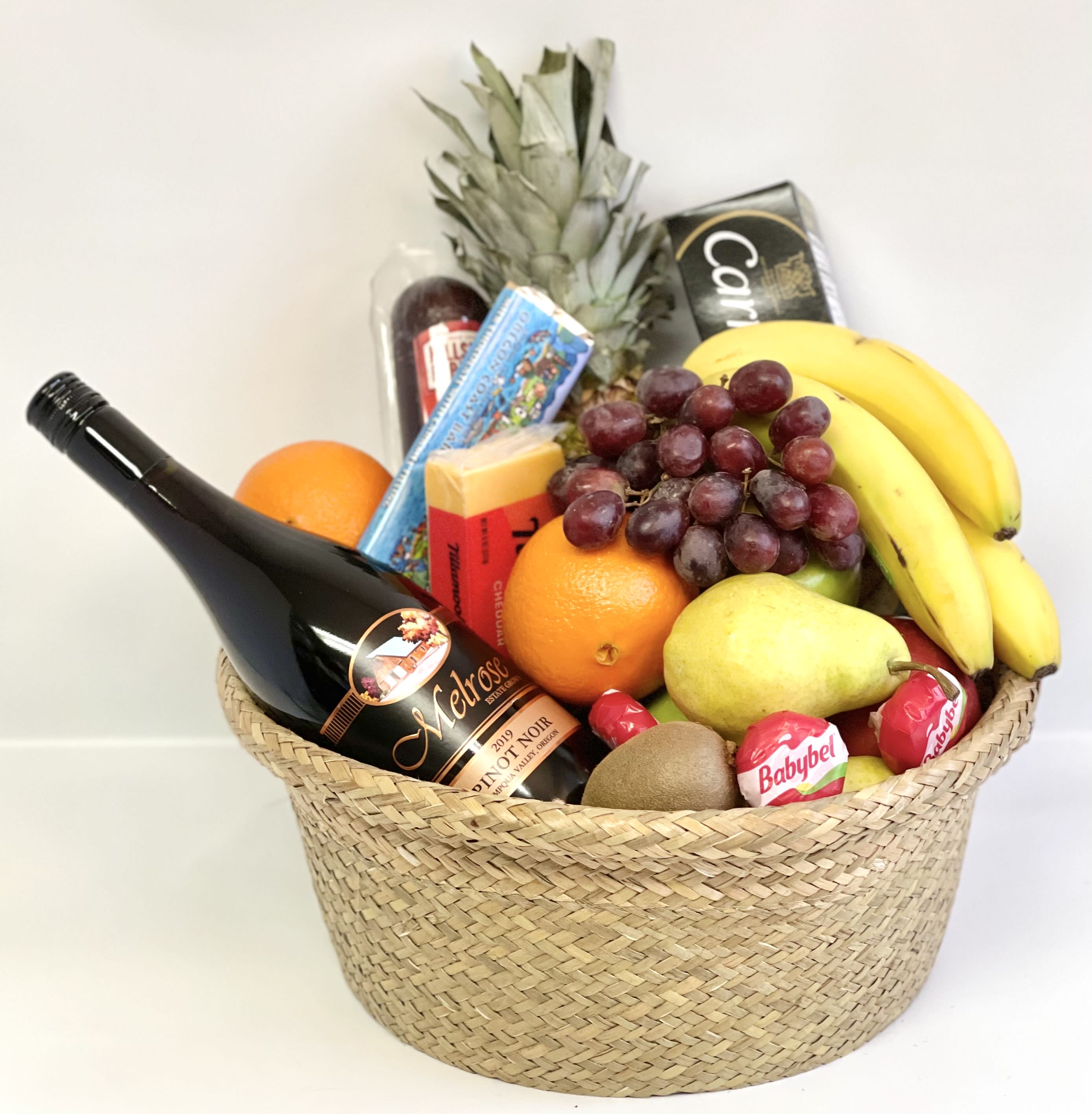 Gift basket with wine, fruit, cheese, and chocolates