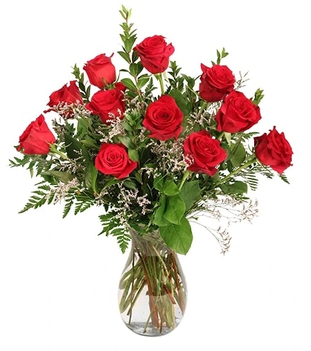 Red roses arranged in a clear glass vase