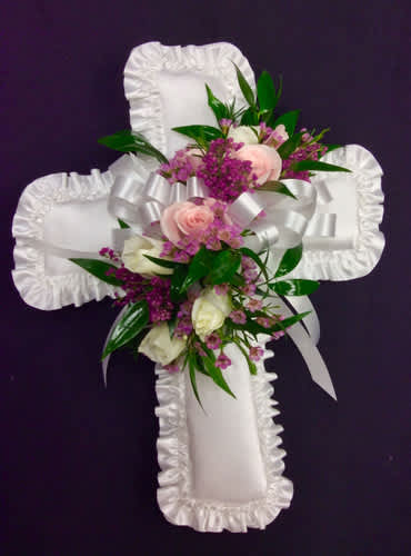 White satin cross with pink and white flowers
