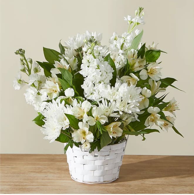 White flowers arranged in a white woven basket