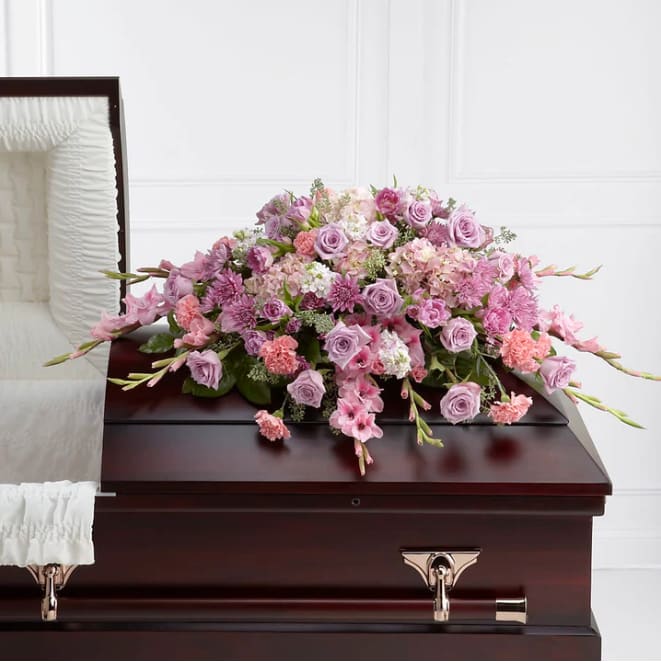 Pink and lavender floral spray on a casket