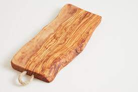 Wooden serving board with a clear handle on a white background
