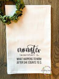 White towel with a floral wreath and "momster" text