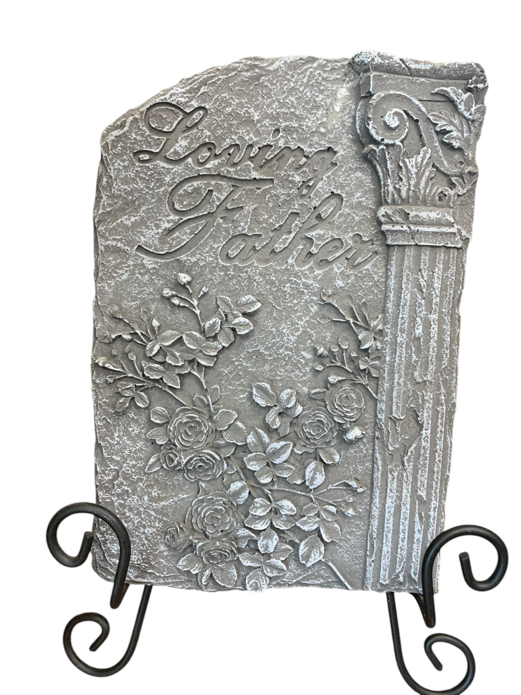 Decorative stone plaque reading "Loving Father" with floral relief