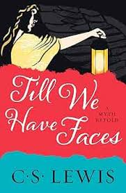 Book cover with a woman holding a lantern and the title Till We Have Faces