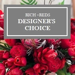 Red floral arrangement with a designer's choice sign