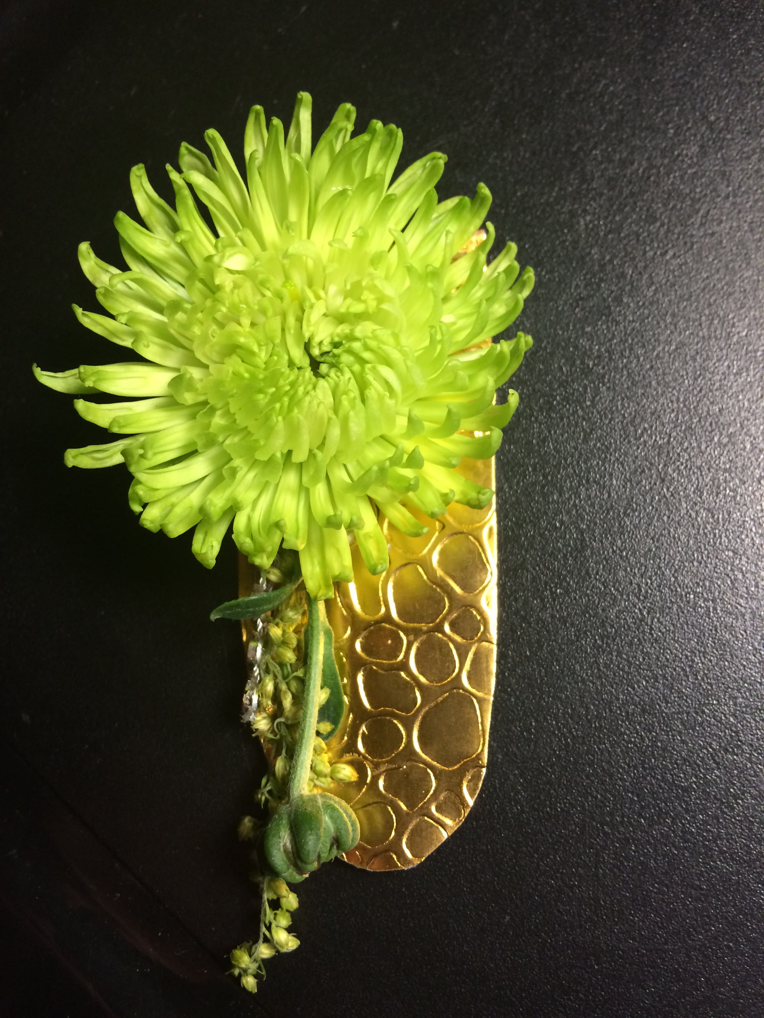 Bright green chrysanthemum boutonniere with a gold textured ribbon