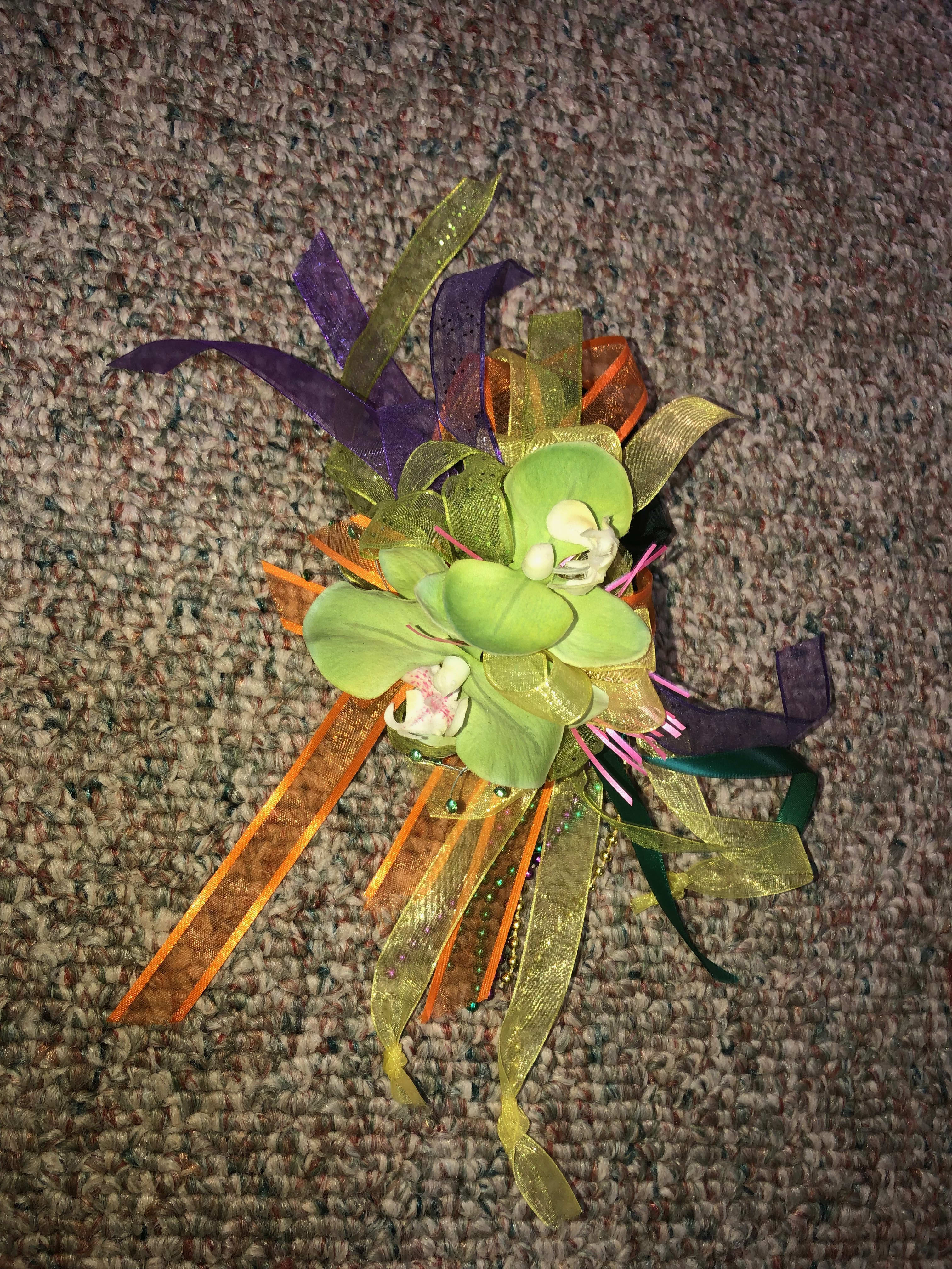 Small orchid corsage with colorful ribbon streamers