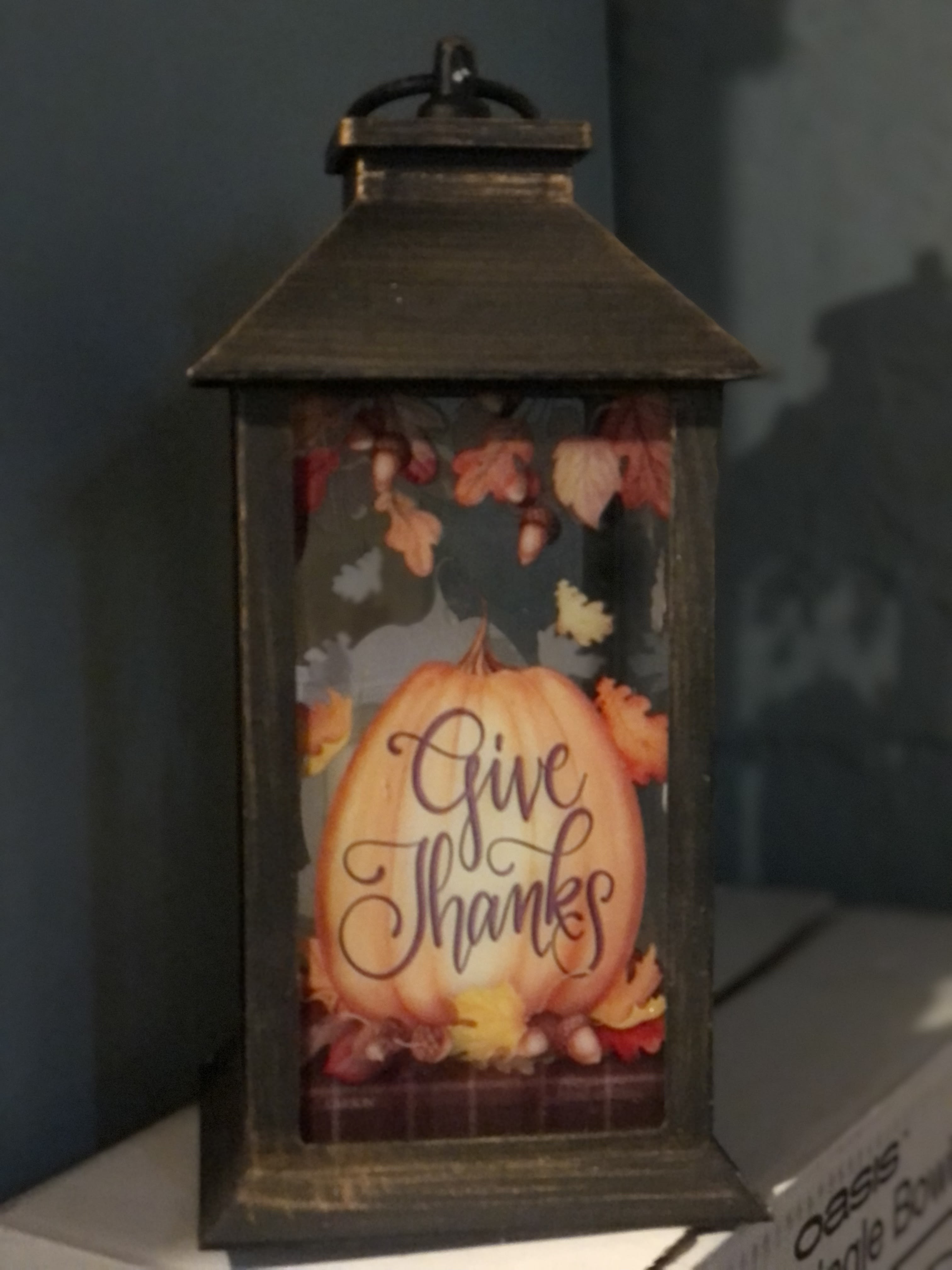 Decorative lantern with a pumpkin and "Give Thanks" text