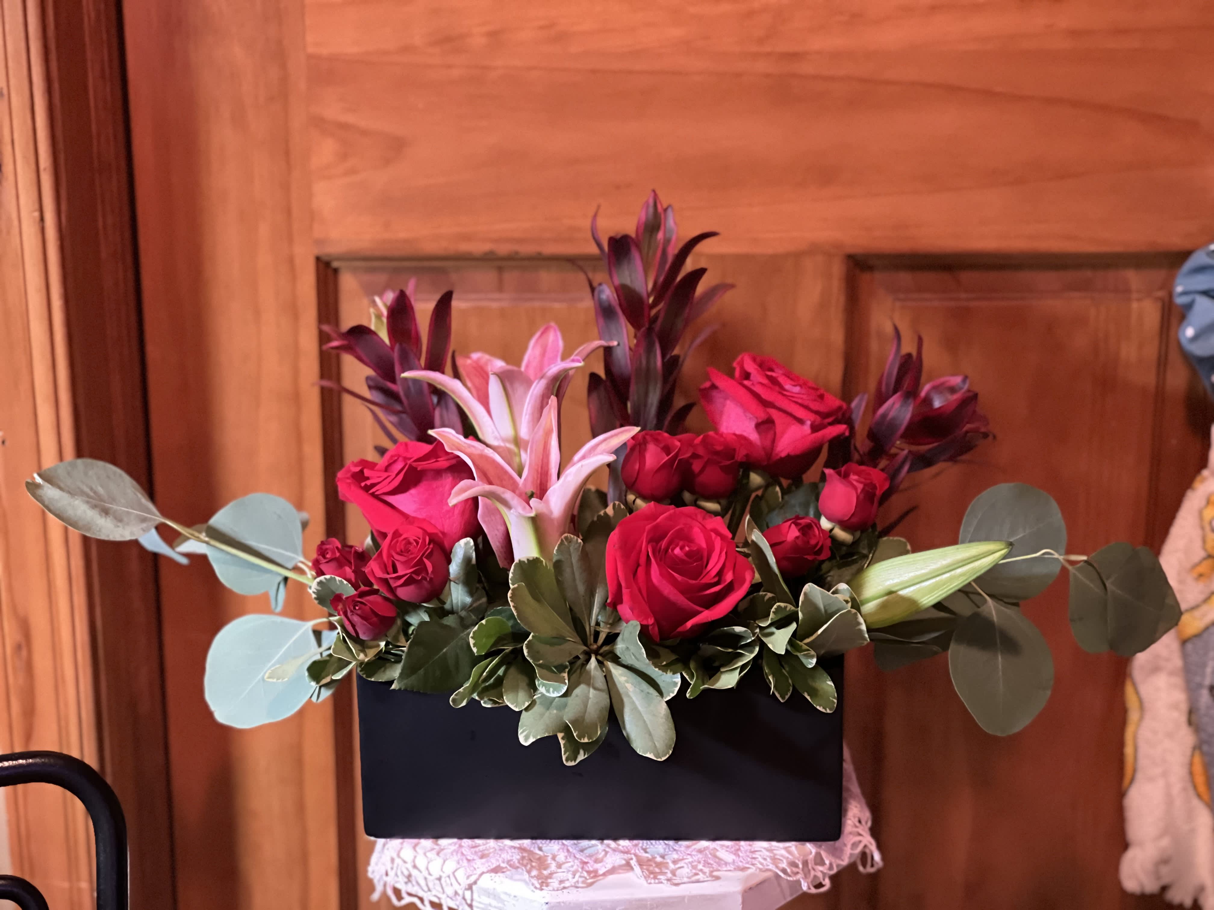 Amazing Grace - A stunning arrangement of lilies and colorful roses, mixed with an assortment of greenery and presented in a ceramic container, ****NOTE: Container will be a black rectangular. (one shown is no longer available)  can be used to ornament any at-home or business event. An excellent all-purpose selection. (Tell us what color of roses in the comments when checking out.) Inventory count: 1 