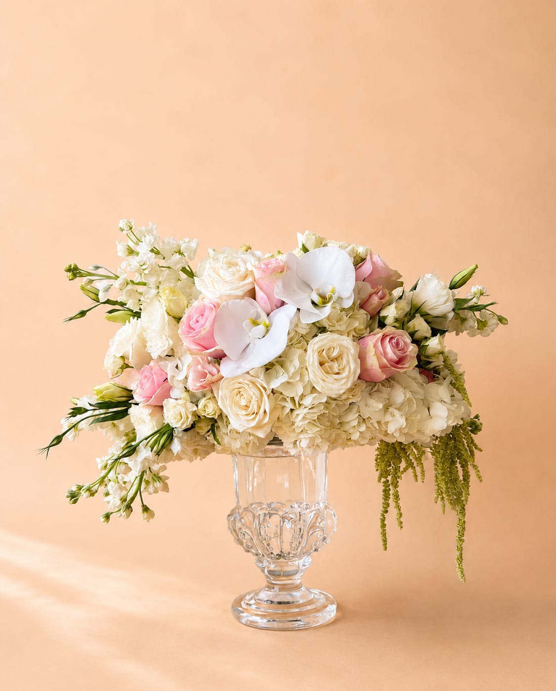 Pink and white floral arrangement in a clear glass vase