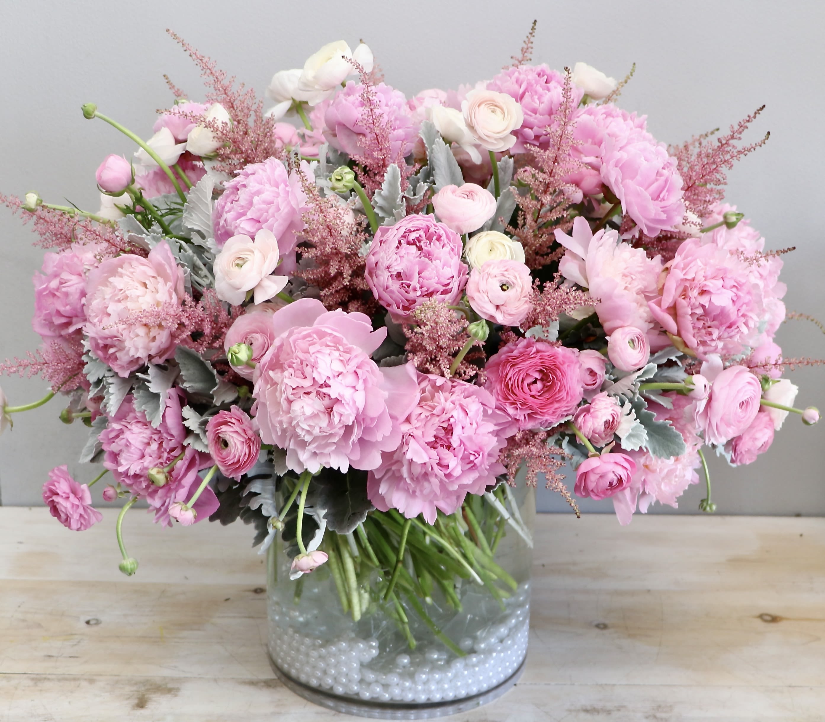 Peony Petals - My Glendale Florist  - Peonies are the focal point of this arrangement! We've layered peonies with white and pink ranunculus for a full and lush design, in a glass vase. The picture shown is in the standard size, don't forget to upgrade for more blooms! 