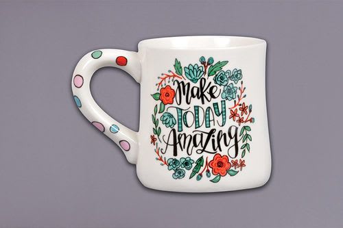 White mug with floral lettering that says "Make Today Amazing"