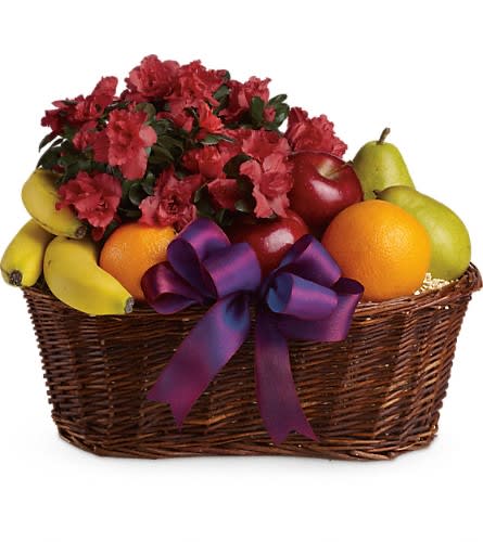 Fruit basket with red flowers and a purple ribbon