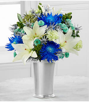 Starry Nights Bouquet - Picked fresh from the farm to bring the majestic beauty of the winter season straight to your special recipient's door, the Starry Nights Holiday Bouquet is an unforgettable Christmas or Hannukah gift they are sure to love! Hand gathered in select floral farms, this stunning flower bouquet flaunts blue, white, green, and sparkling silver hues and has been picked fresh for you to help your friends and family celebrate the holiday season in style. This bouquet includes: white LA Hybrid Lilies, tinted blue Fuji Mums, green carnations, tinted green button poms, tinted green solidago, tinted green rice flower, tinted silver thistle, and tinted green Israel ruscus BEST bouquet includes 17 stems with a silver vase. Approximately 18"H x 15"W. Your purchase includes a complimentary personalized gift message.
