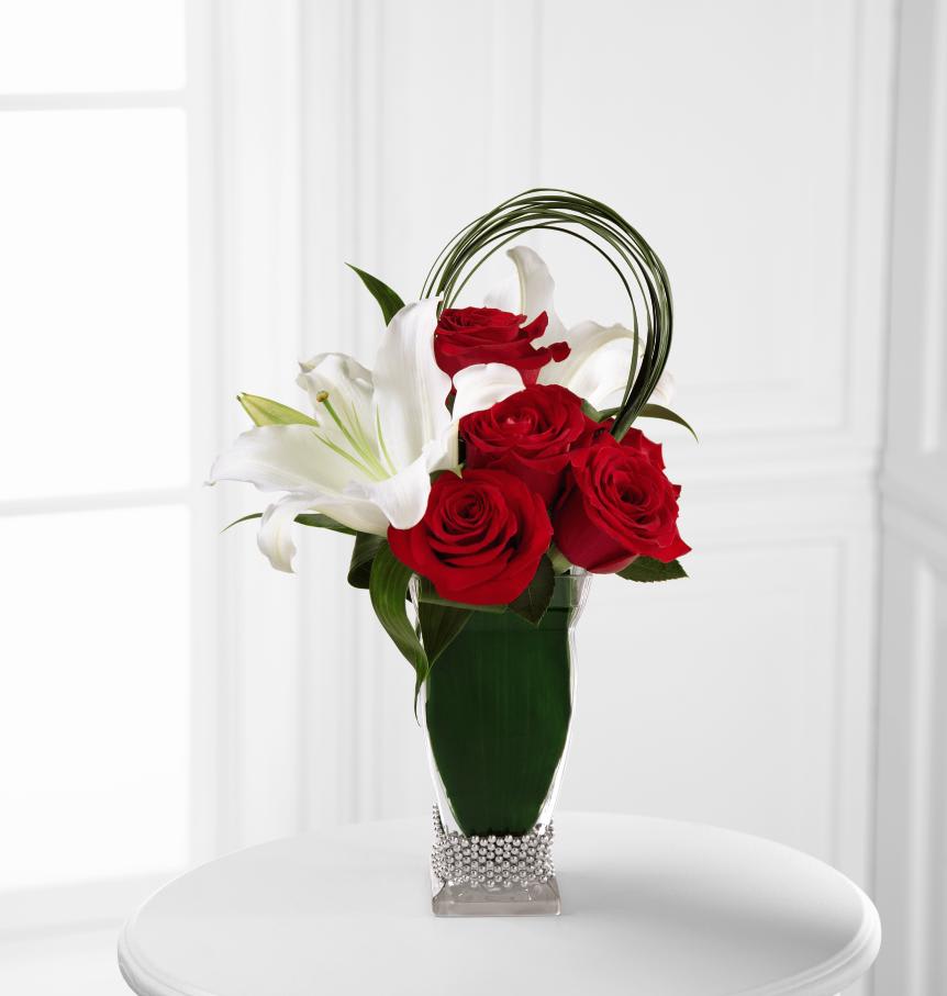 The FTD Pure Passion Bouquet - The FTDÂ® Pure Passionâ¢ Bouquet is rich in romance and sweet sophistication. Red roses combine with white Oriental lilies artistically accented with lily grass blades for an incredible look. Wrapped in aspidistra leaves around the stems, this bouquet arrives seated in a clear glass vase presented with a sterling classic beaded flower bracelet at the base to create the perfect atmosphere for love to bloom. GOOD bouquet includes 6 stems. Approx. 15âH x 10âW. BETTER bouquet includes 8 stems. Approx. 16âH x 11âW. BEST bouquet includes 10 stems. Approx. 17âH x 11âW.