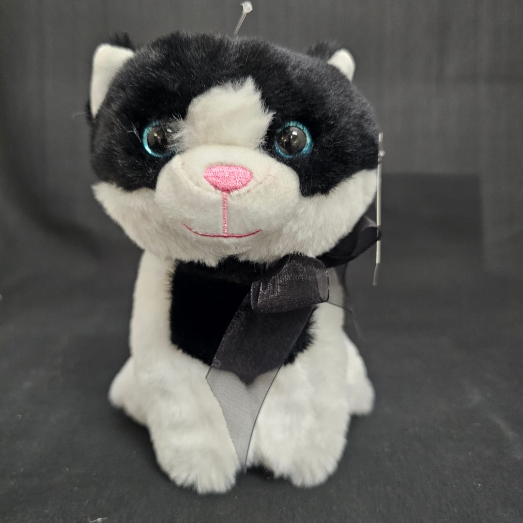 Black and white plush cat with a ribbon bow
