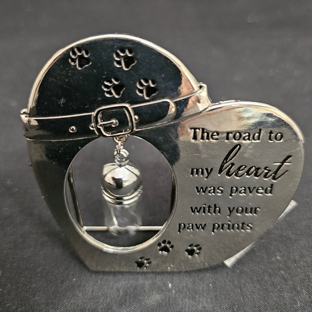 Heart-shaped pet memorial ornament with paw prints and a dangling bell