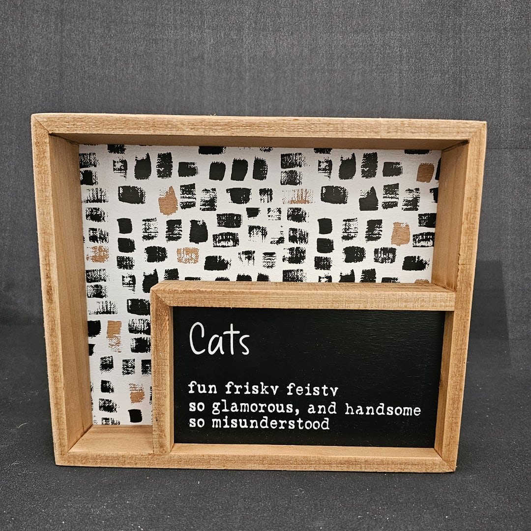Wooden framed cat-themed sign with black-and-white patterned backing