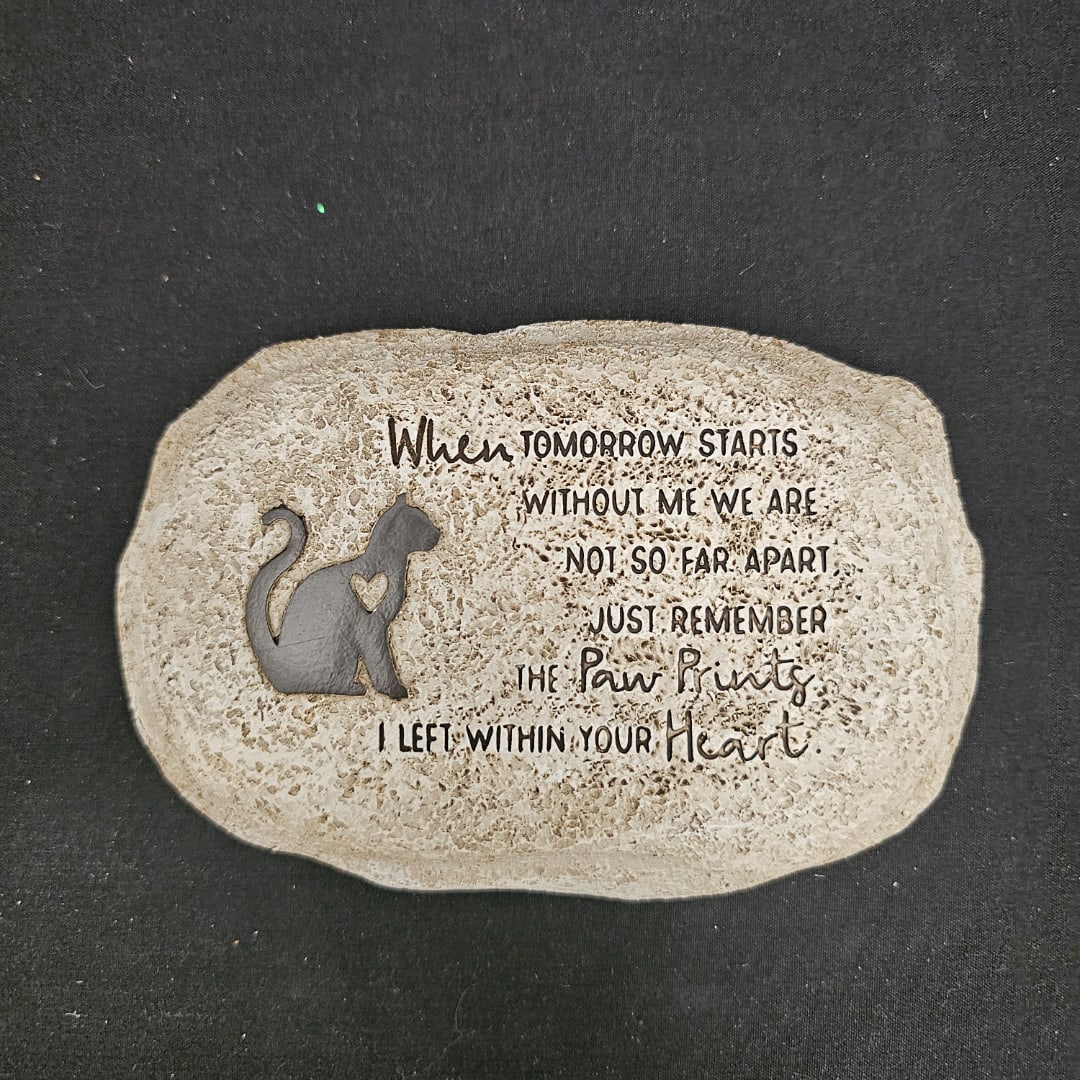 Decorative stone plaque with a cat silhouette and memorial text