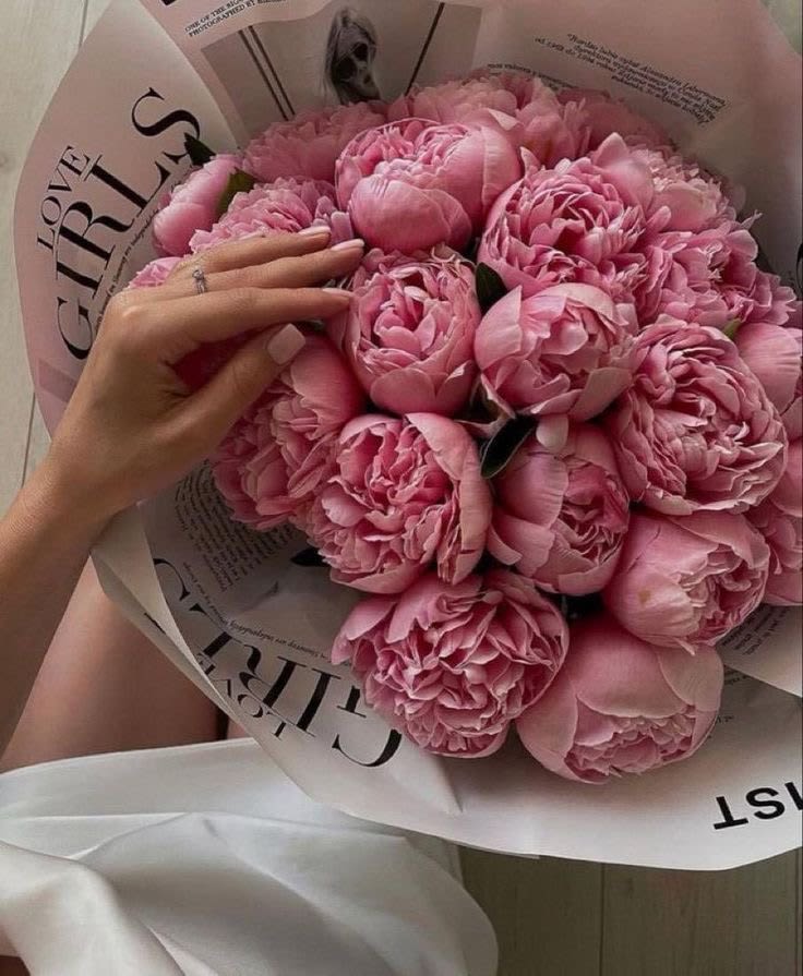 Pink peony bouquet wrapped in white paper