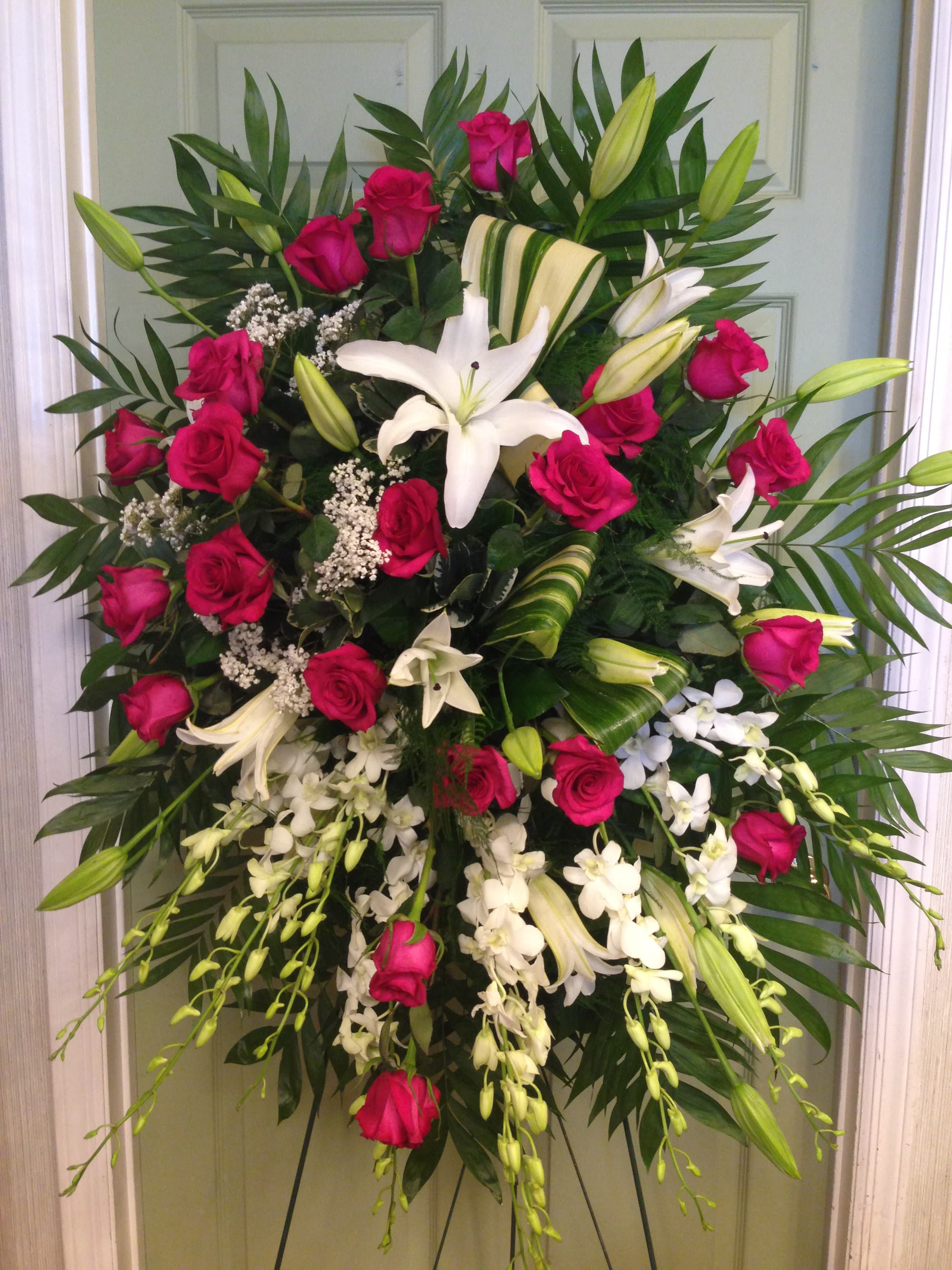Standing spray of pink roses and white lilies with orchids