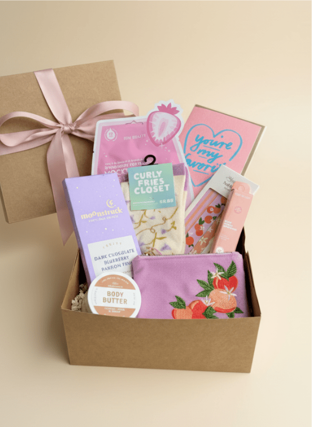 Spoil Her Gift Box - A gift box to spoil someone that includes a few of our favorites items! Gift box starts out with a sweet treat, facemask, greeting card, body butter, nail file, socks, lip gloss and mini zip pouch! Upgrade for more items!  (Substitutions may occur as needed)