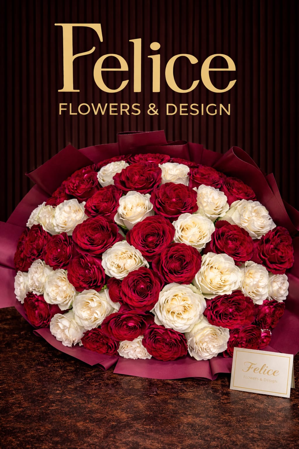 Bouquet of red and white roses wrapped in burgundy paper