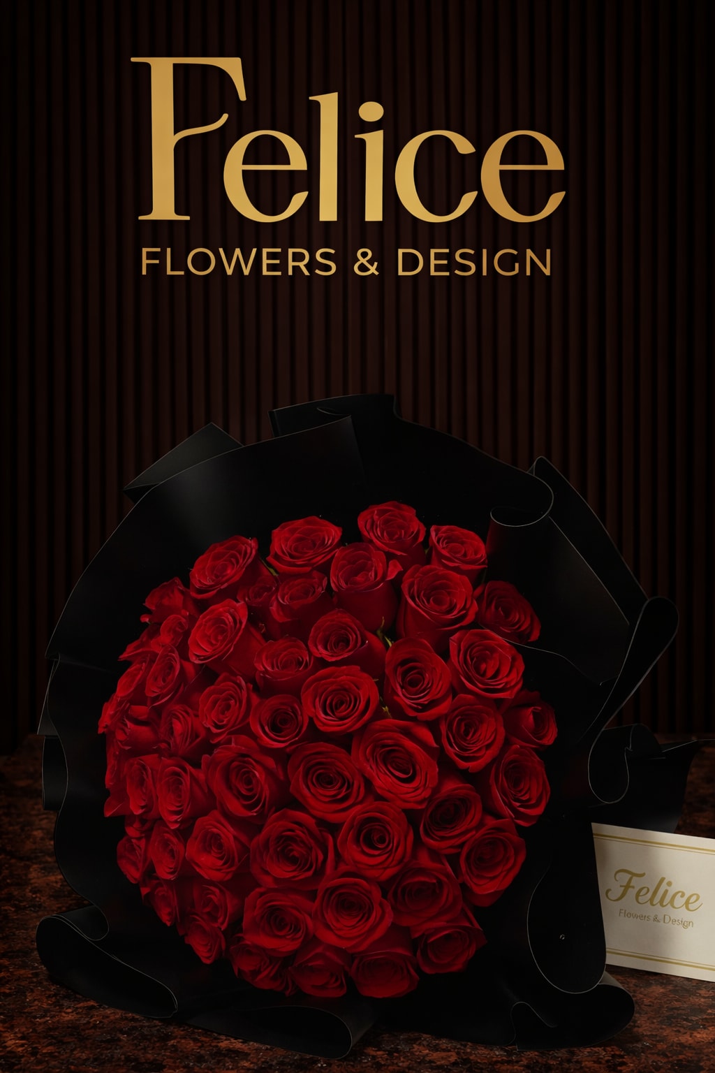 A large bouquet of red roses wrapped in black paper.