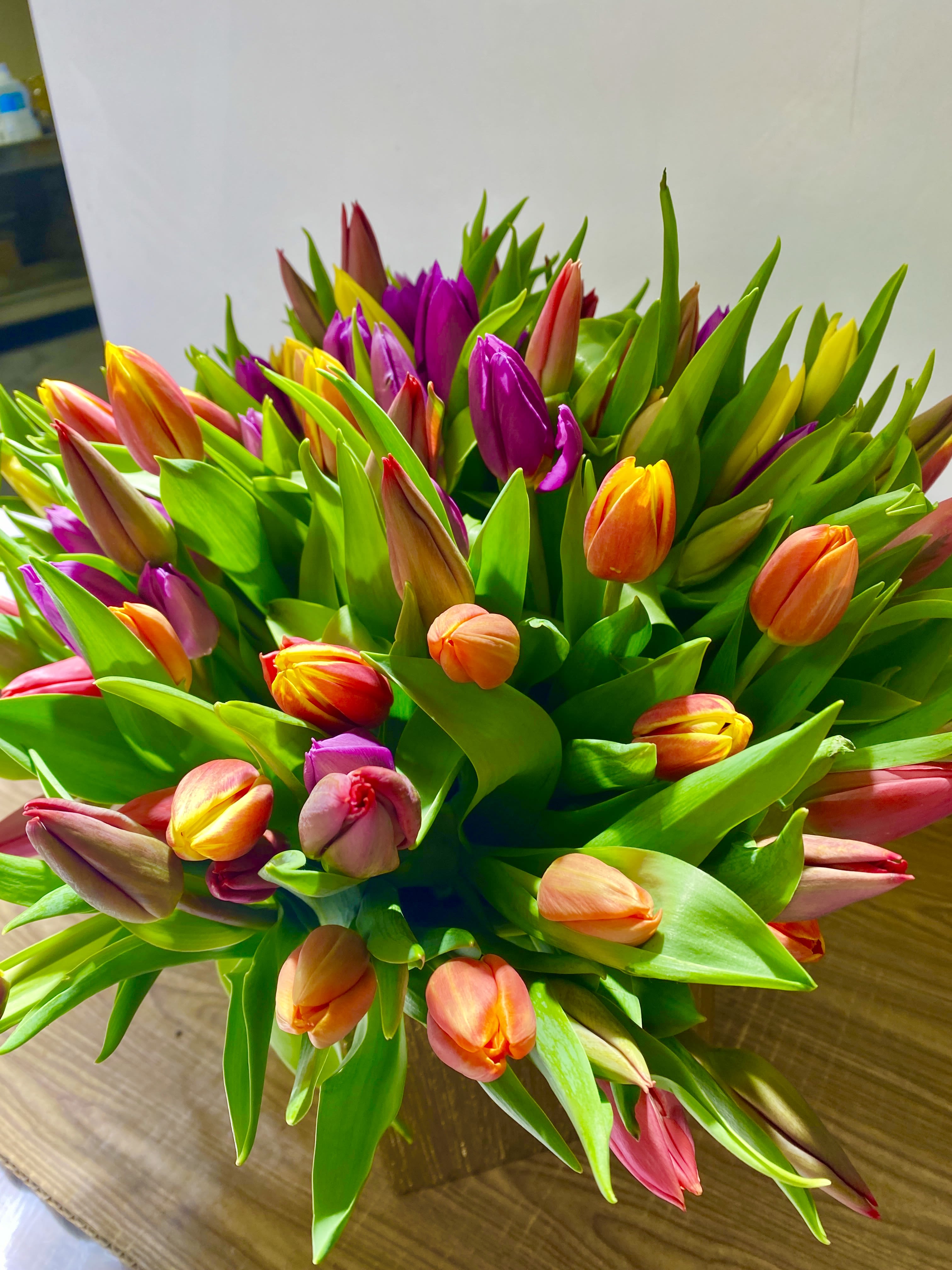 BLIND DATE - 100 stems of different colors of tulips in a beautiful pink ceramics vase