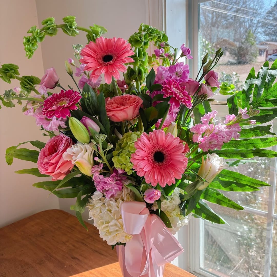 Pink and white mixed bouquet in a vase with a ribbon