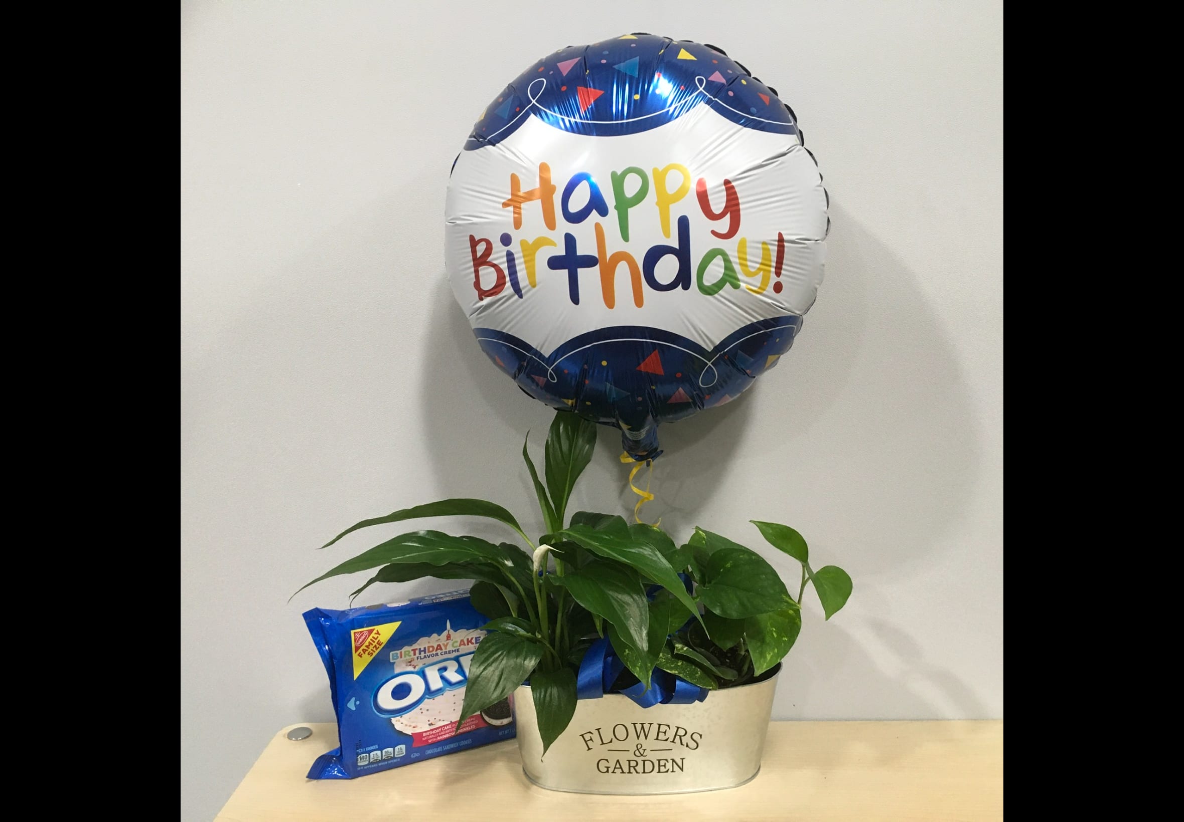 Birthday balloon with a potted plant and Oreo cookies in a gift container