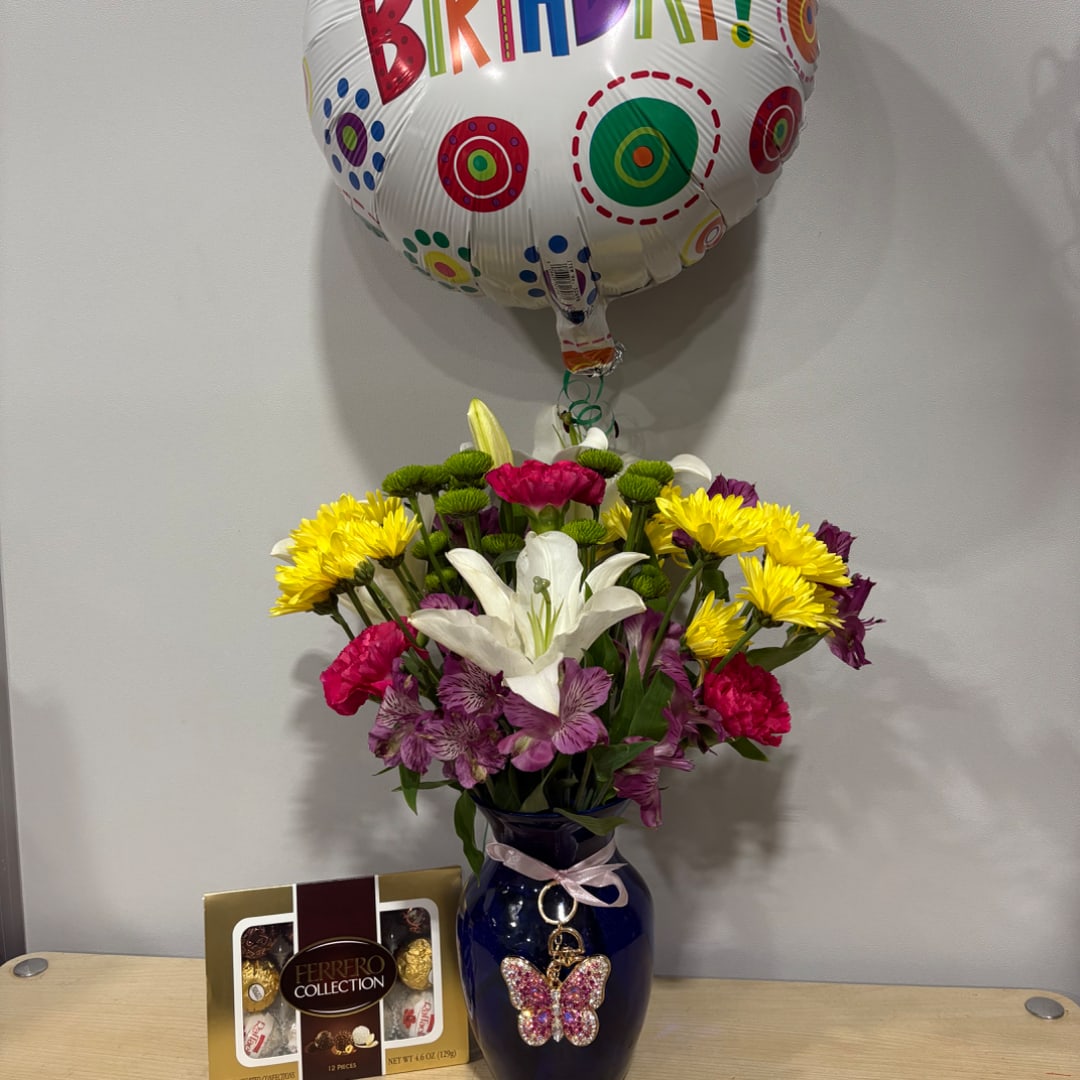 Mixed bouquet in a blue vase with a birthday balloon and chocolate box