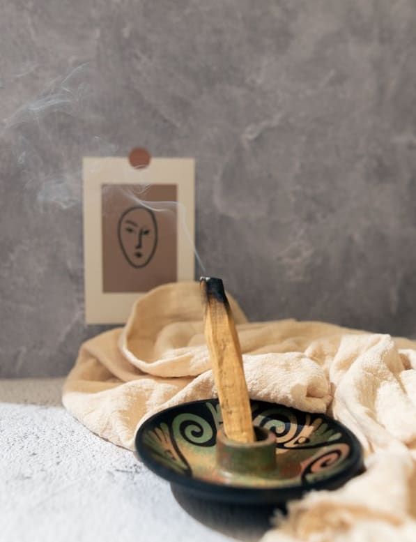 Burning incense in a decorative bowl with a small card behind it