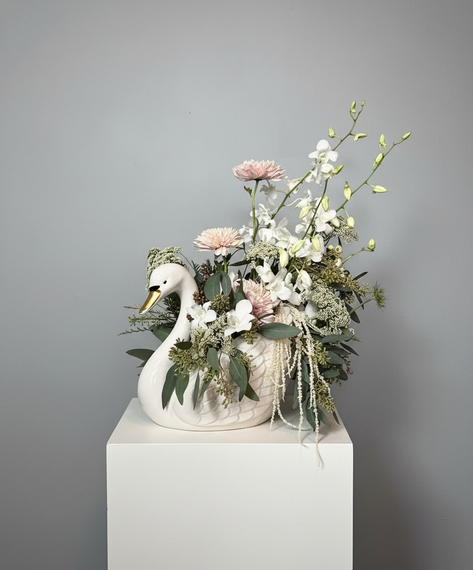 Swan Love - Swans are seen as a symbol of love because of their long-lasting relationships. Swans are known for their strong bonds with their partners! Perfect arrangement for the lovers!  Because flowers follow the rhythm of the seasons, availability changes often. Your arrangement may vary from the photo, and some varieties may differ. We design with the freshest blooms available, making substitutions when needed—while always preserving the overall mood: fresh, artful, and beautifully composed.  For specific flower or color requests, please contact us before ordering. 
