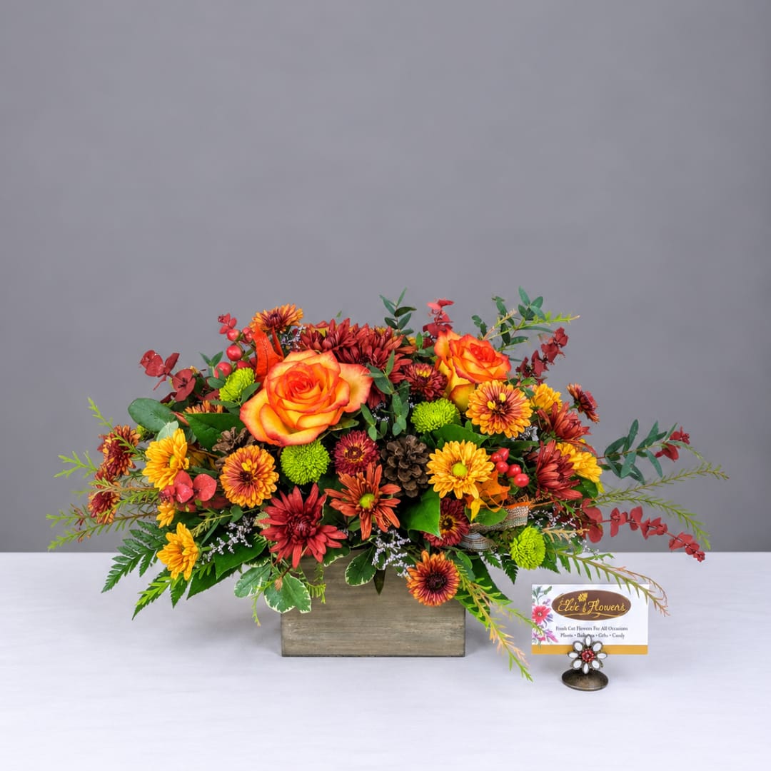 Orange roses and mixed fall flowers in a wooden box arrangement