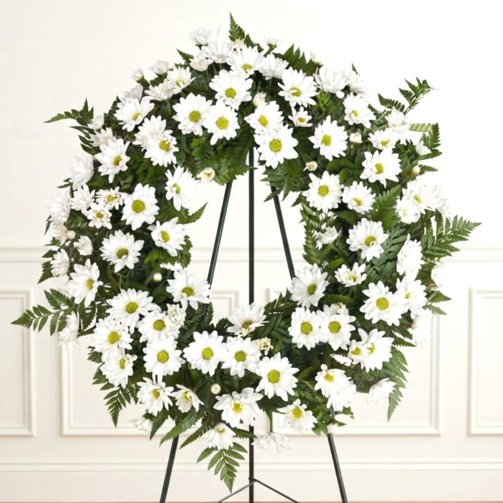 White daisy wreath on a black stand