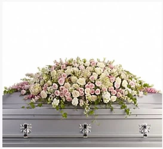 White and pale pink flowers arranged on a silver casket