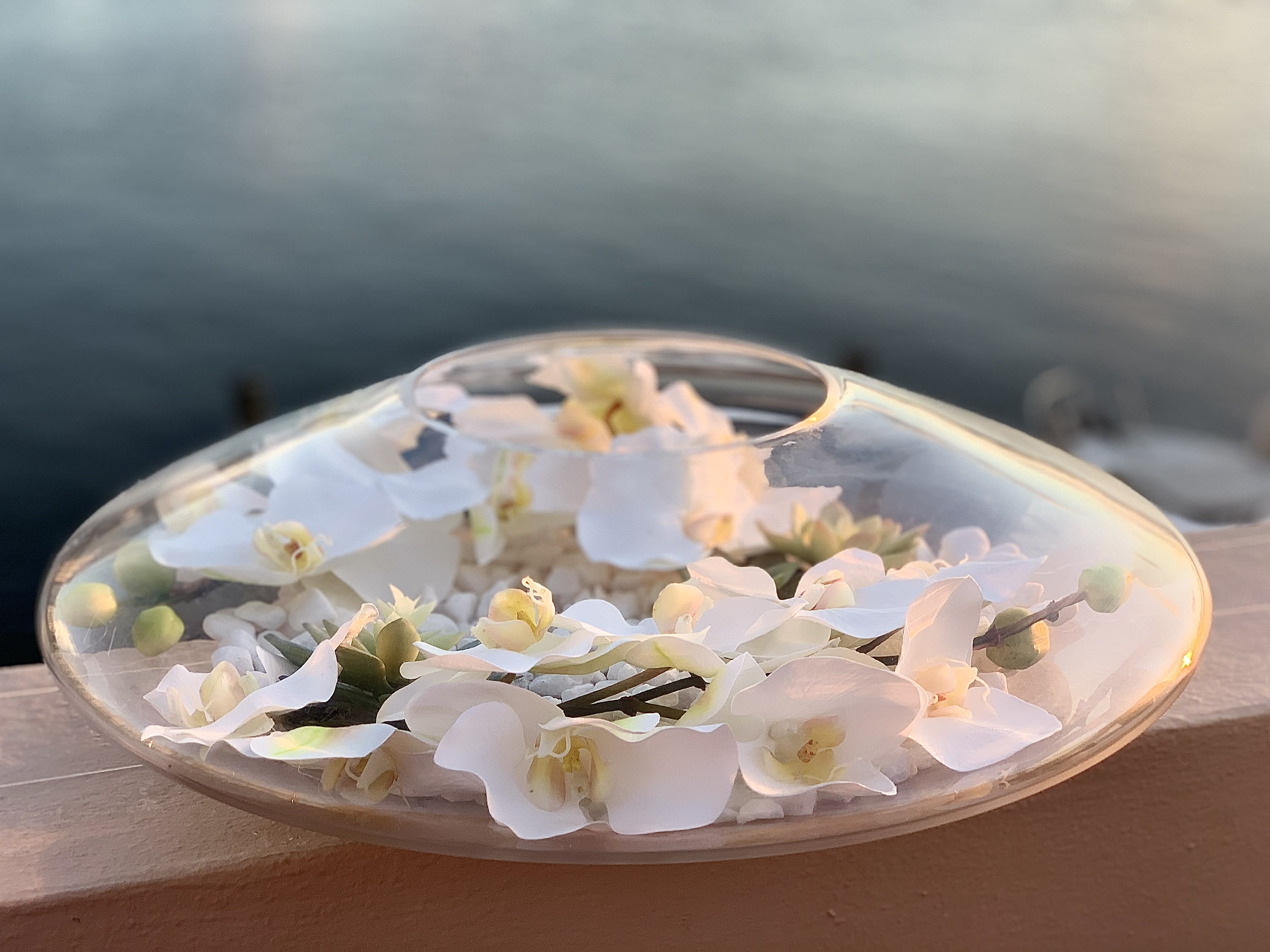 Epiphany - Silk orchids with stones and succulents in clear vase. Custom made. Beautiful decor for your home.   Silk flowers are crafted from a protein fibre spun by the silk worm, producing lifelike flowers. Flowers described as being made of silk with a "real touch technique" are not made of silk, but rather are made of polyester, polymers and plastics.  Pre order 2 days.  ▪️ Delivery to their door Each bouquet is unique and is prepared by an expert florist and our customer service team is at your service to ensure the best experience possible.  ▪️Bouquets you can enjoy for longer Some flowers arrive a little closed to ensure extra freshness and protection during shipping. Enjoy the magic of seeing them fully bloom. 