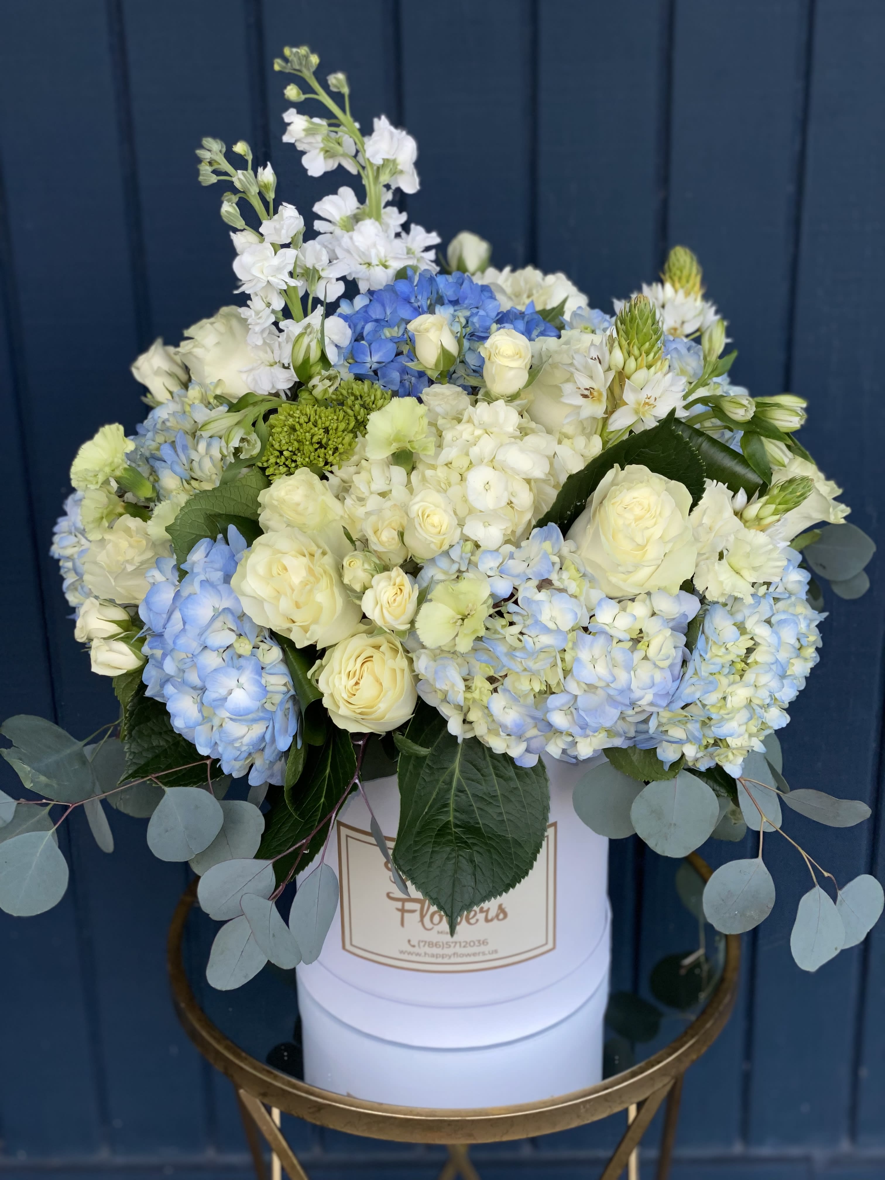 Pretty in Blue - Flowers arrangement with hydrangeas, roses, spray roses, stock.White and blue Colors