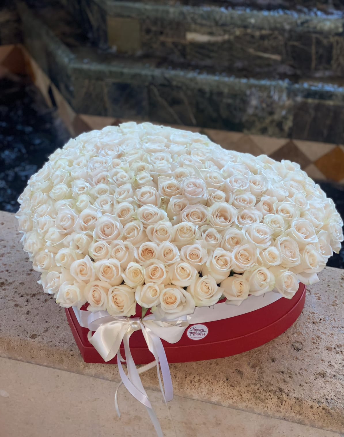 Heart Of Roses White - Big bouquet of white roses in a heart shaped box  *Pictured is premium size  ▪️ Delivery to their door Each bouquet is unique and is prepared by an expert florist and our customer service team is at your service to ensure the best experience possible.  ▪️Bouquets you can enjoy for longer Some flowers arrive a little closed to ensure extra freshness and protection during shipping. Enjoy the magic of seeing them fully bloom.