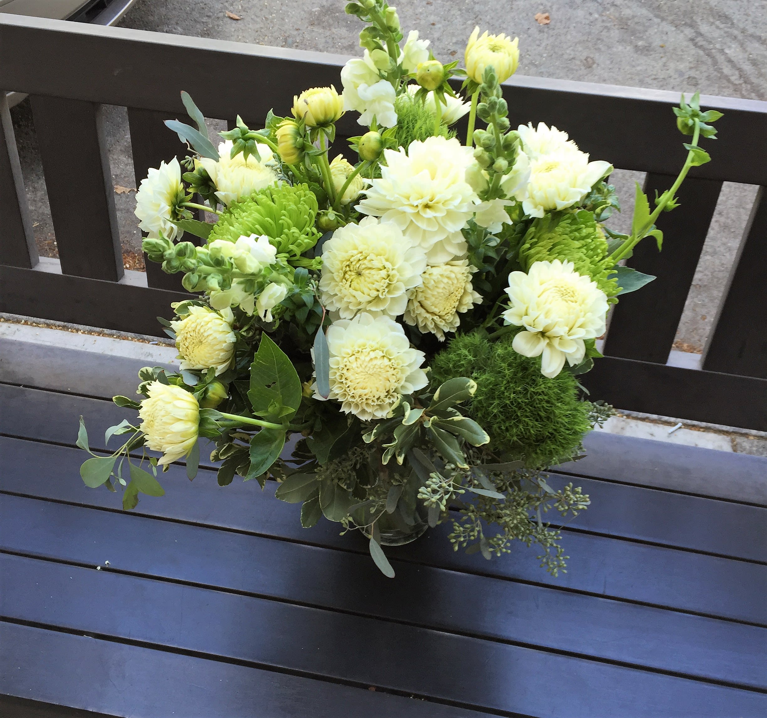 Bouquet of pale yellow and white flowers in a glass vase